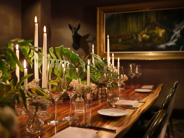 a table with wine glasses and candles