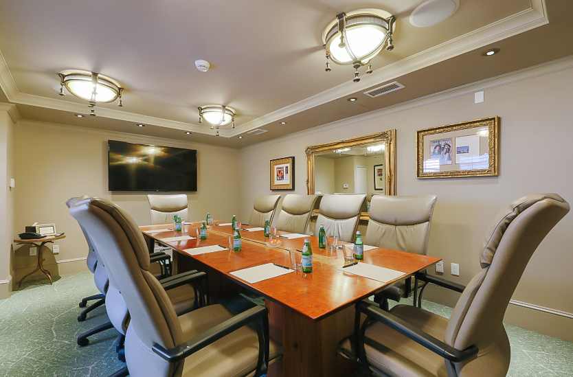 a conference room with chairs and a table with bottles of water