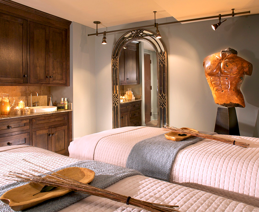 a room with two beds and a mirror