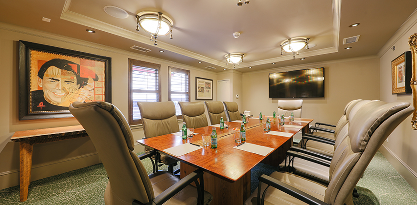 a conference room with chairs and a table with bottles on it