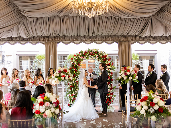 a bride and groom under a canopy