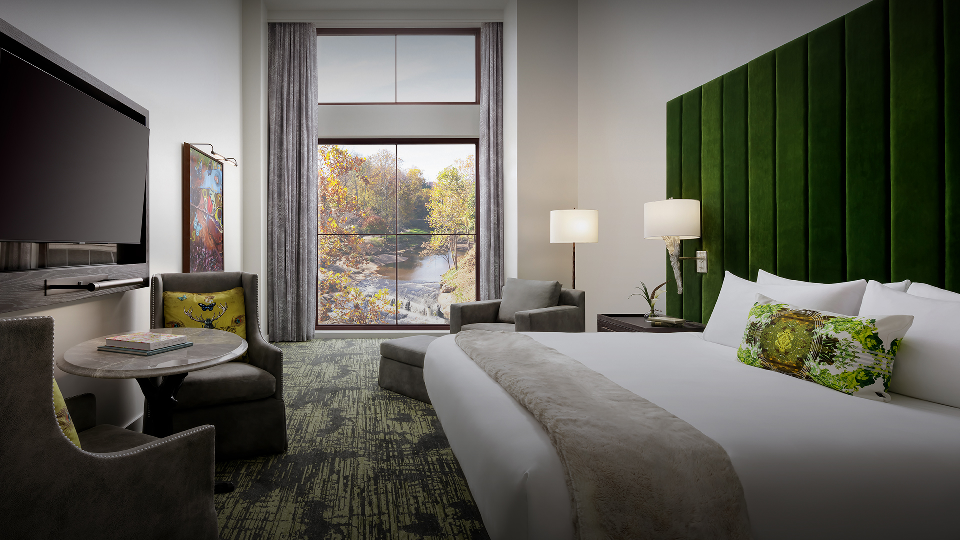 a room with a bed and chairs