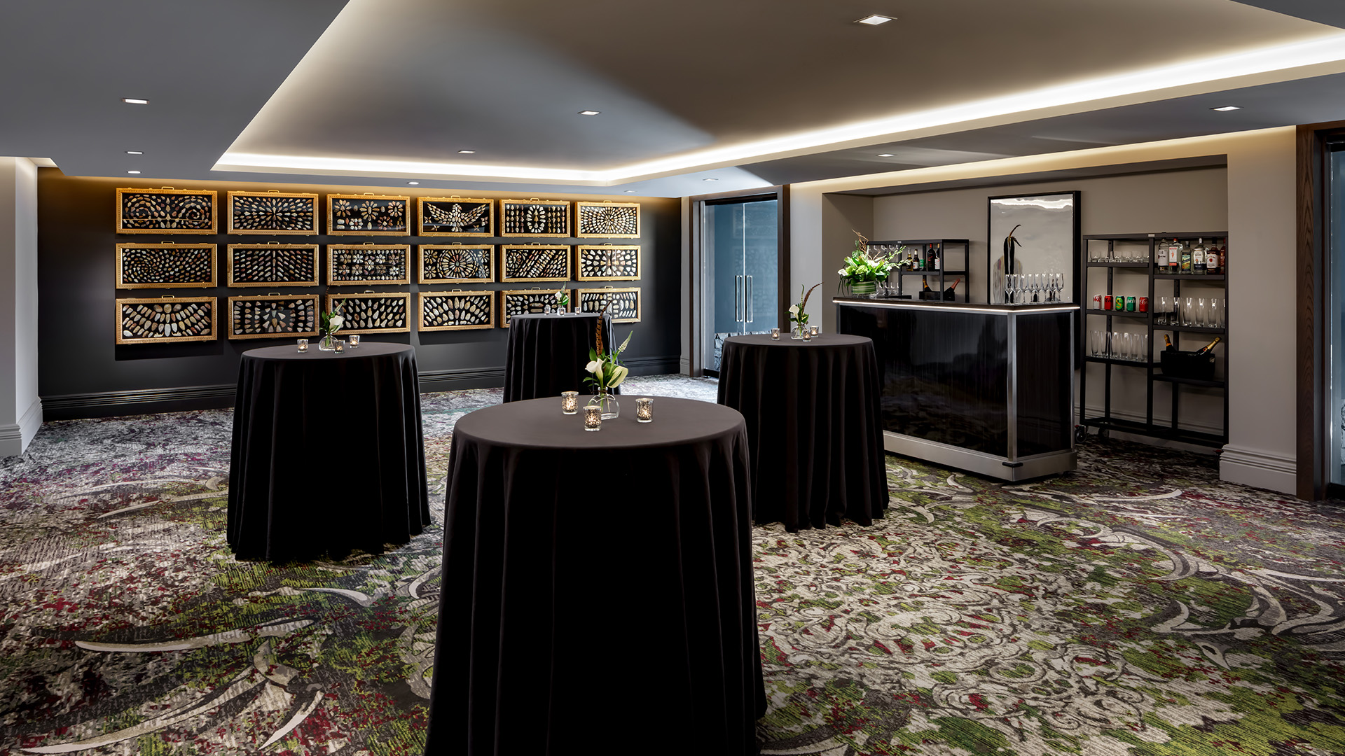 a room with tables and black tablecloths