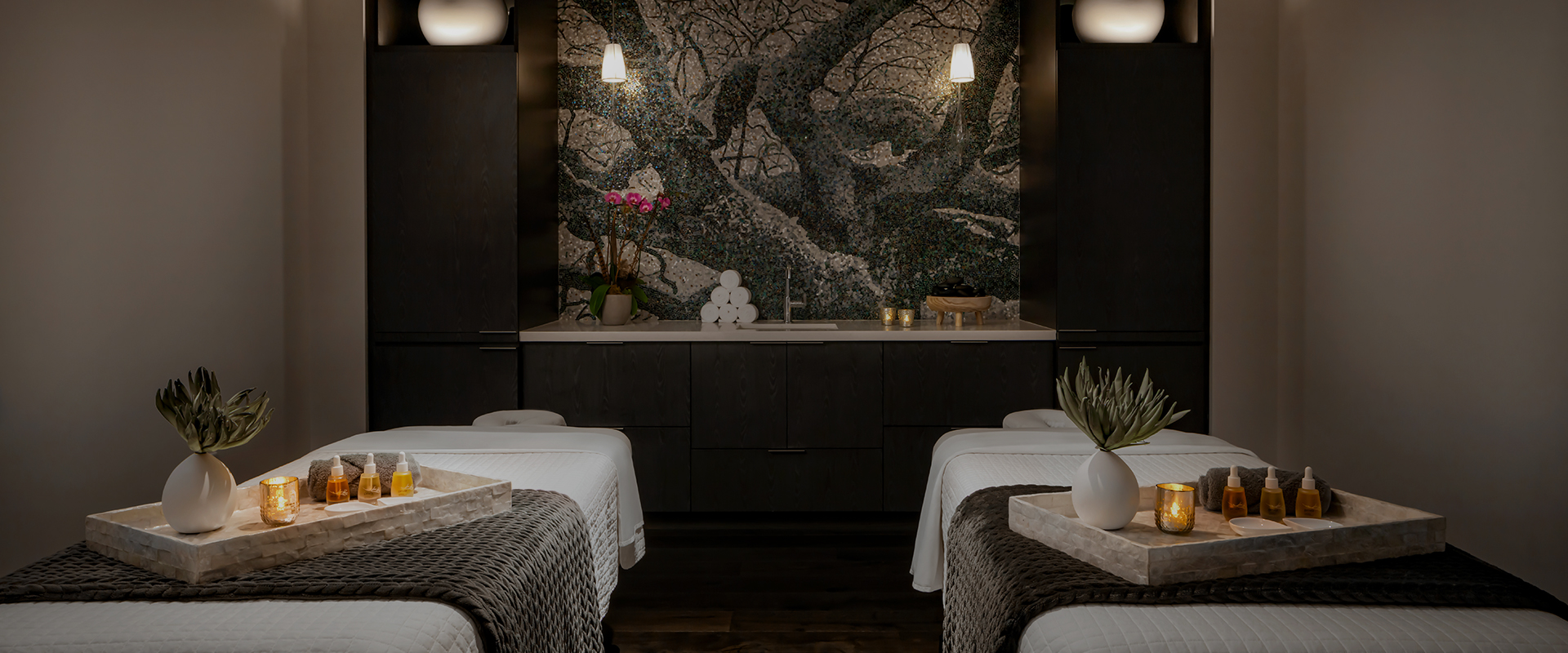 a room with beds and a mosaic wall