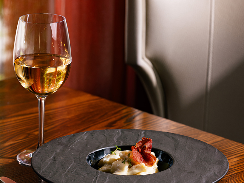a plate of food and a glass of wine