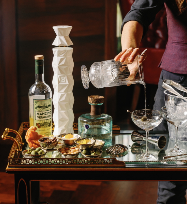 a person pouring liquid into a glass