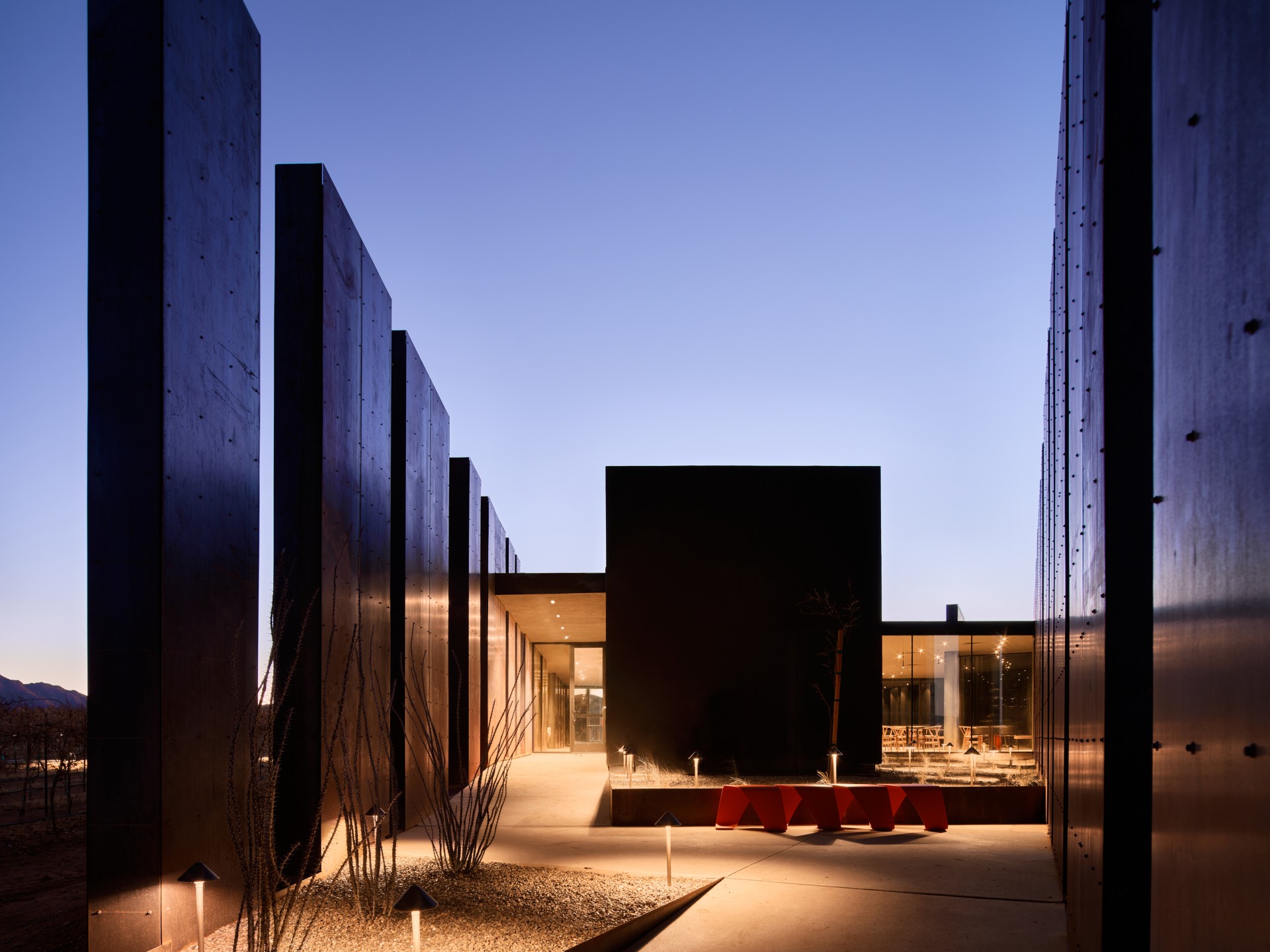 a building with a courtyard and a glass wall
