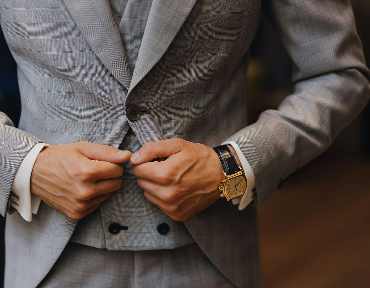 a man buttoning his suit