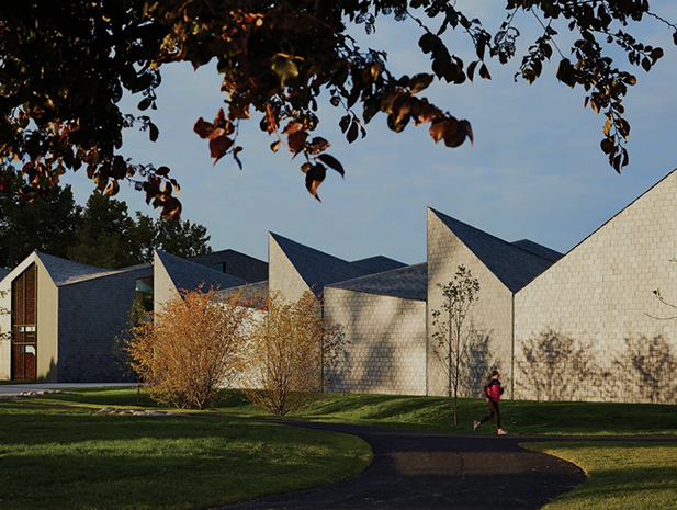 a person walking in front of a row of white buildings