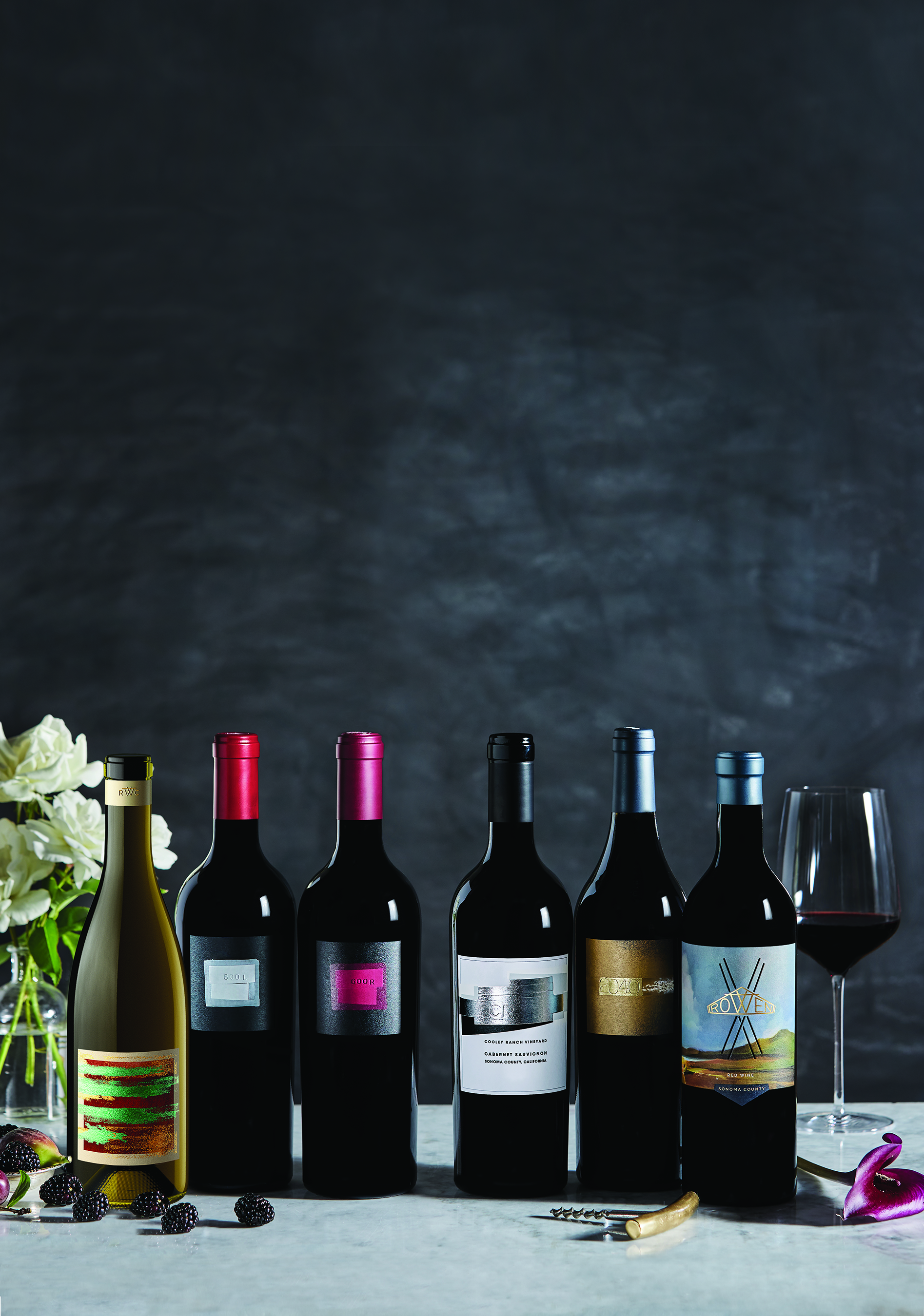 a group of wine bottles and a glass of wine