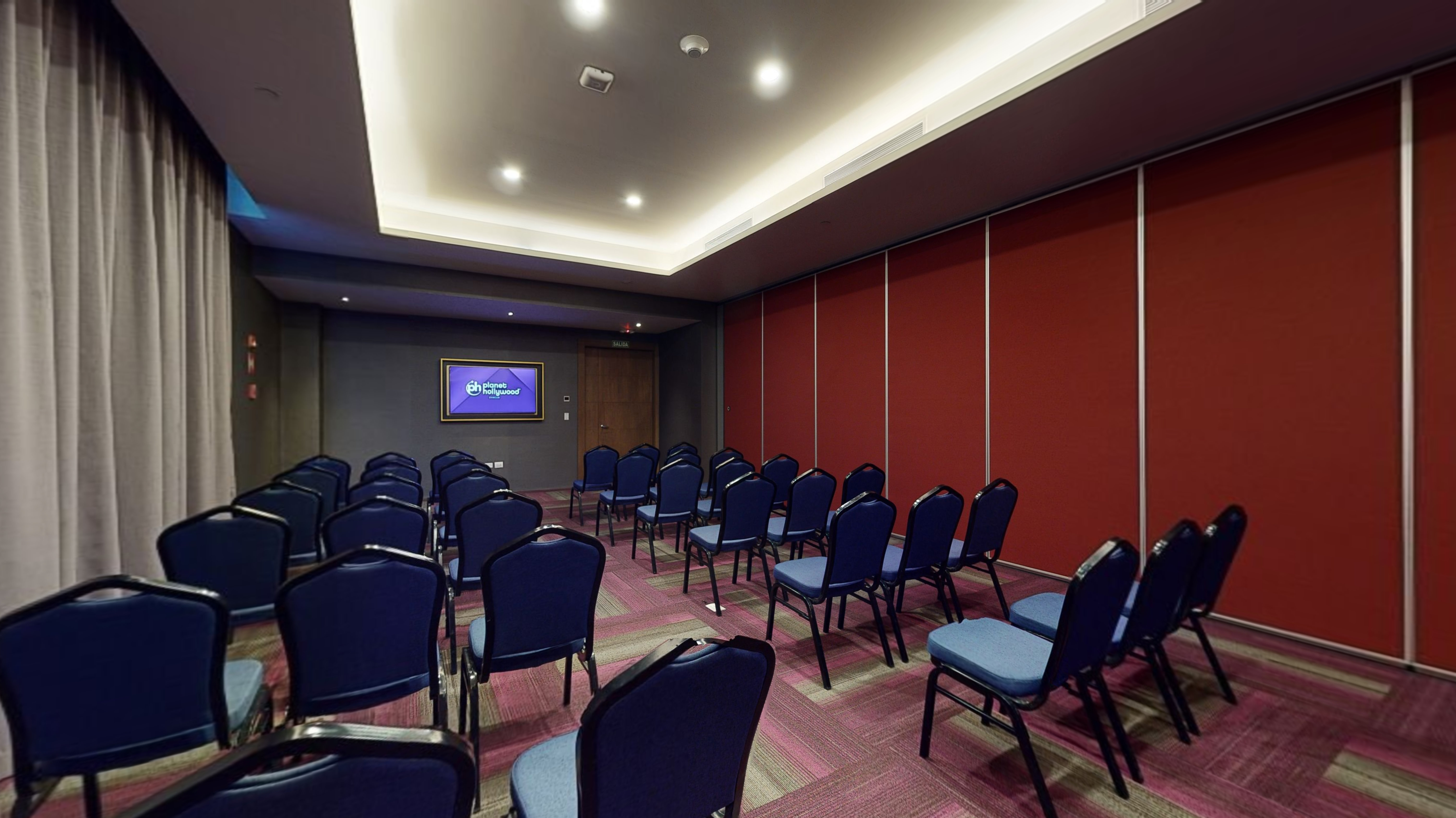 a room with blue chairs and a screen