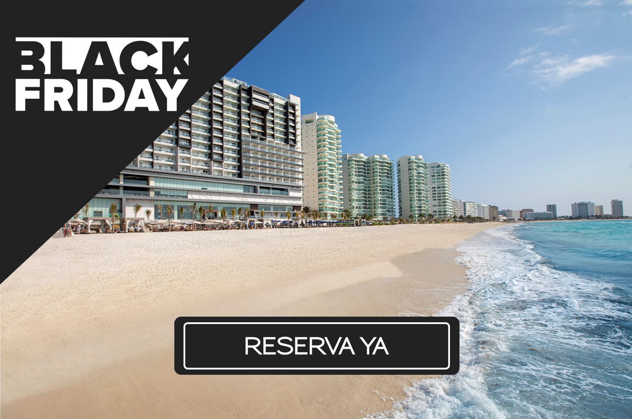 a beach with buildings and waves