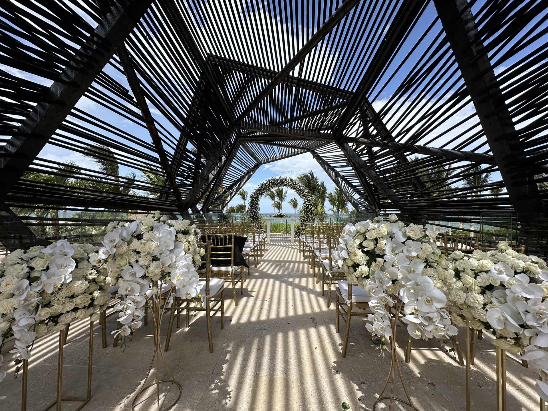 a wedding ceremony with white flowers and chairs
