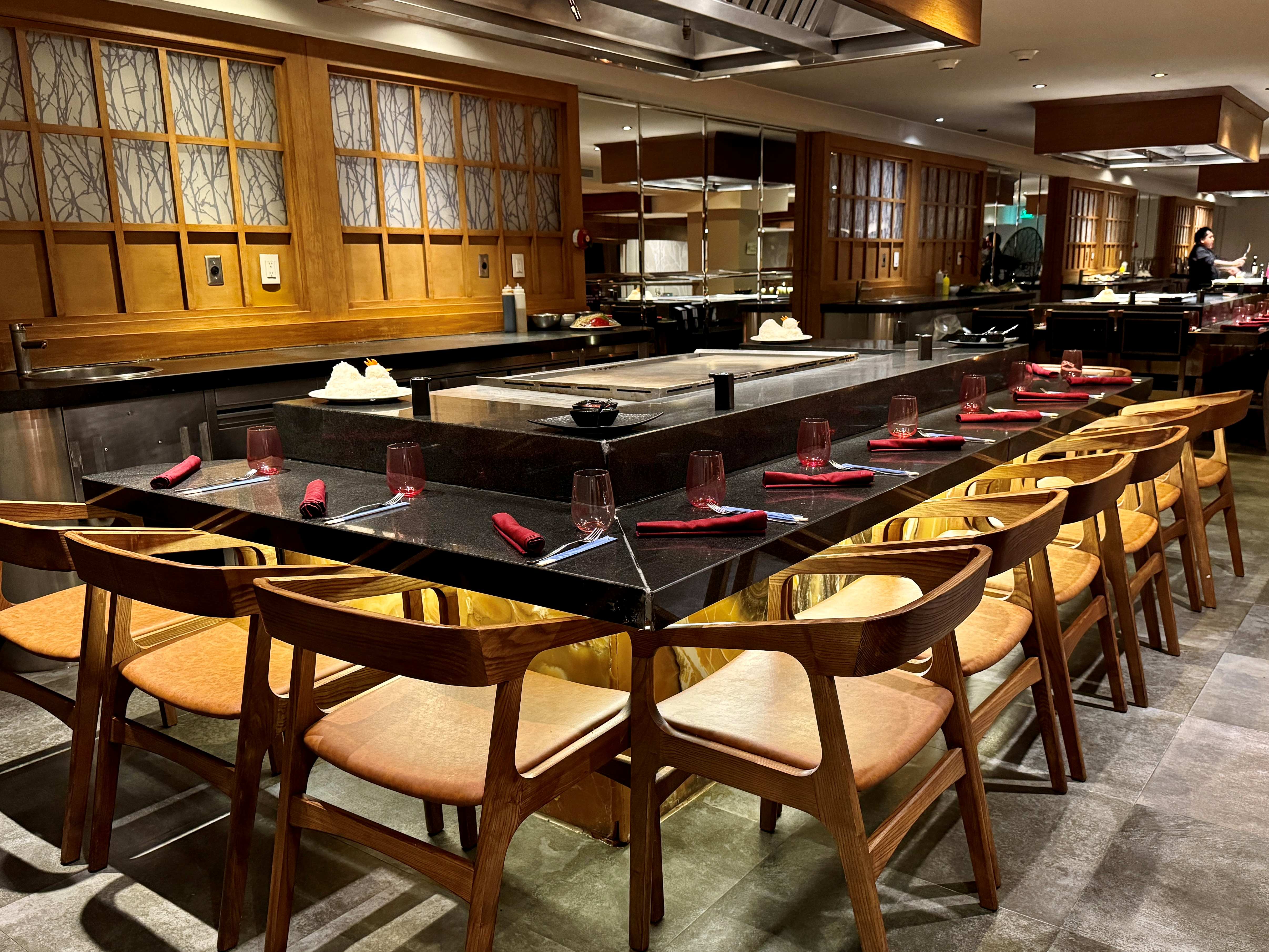 a restaurant with a large table and chairs