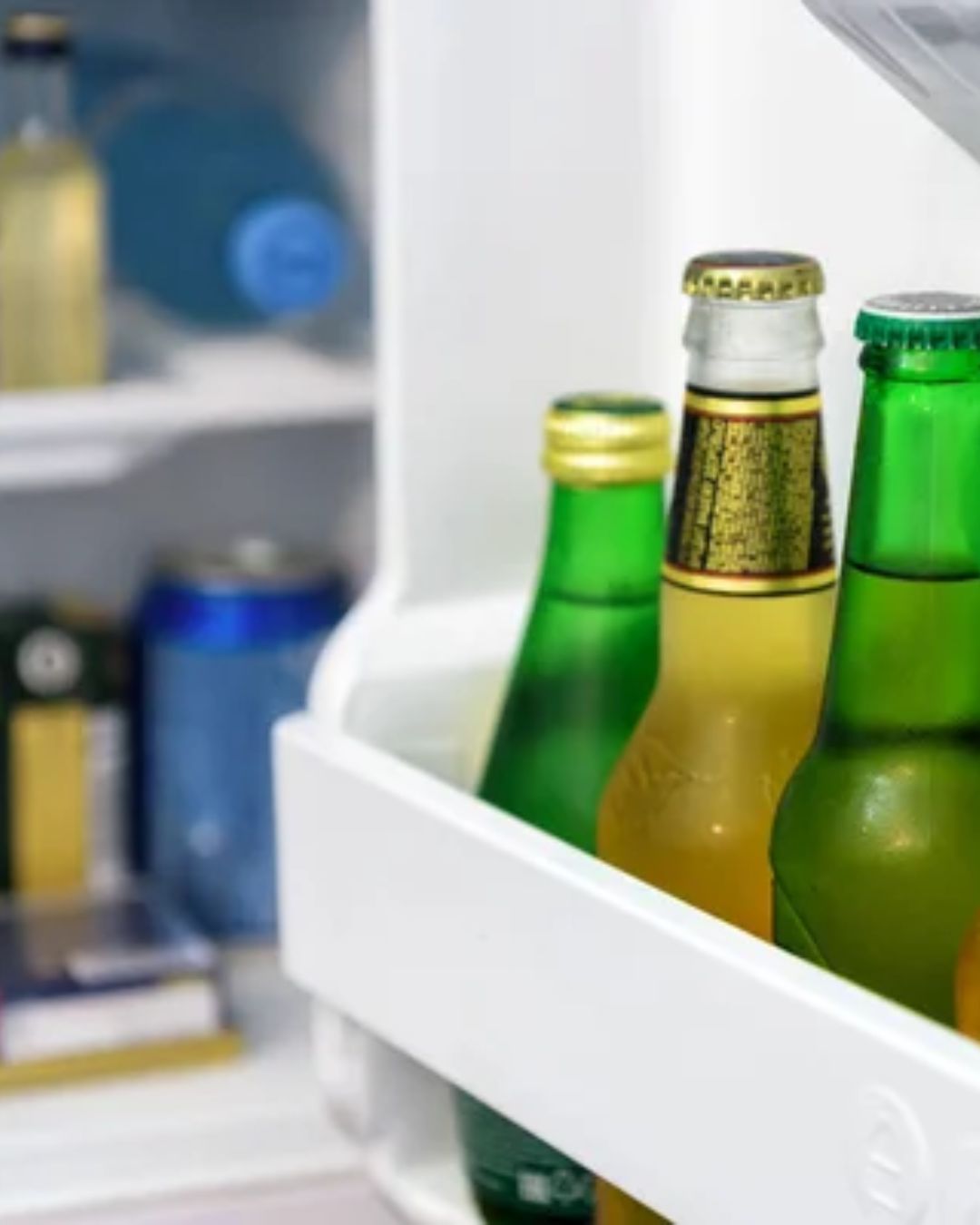 a group of bottles in a refrigerator