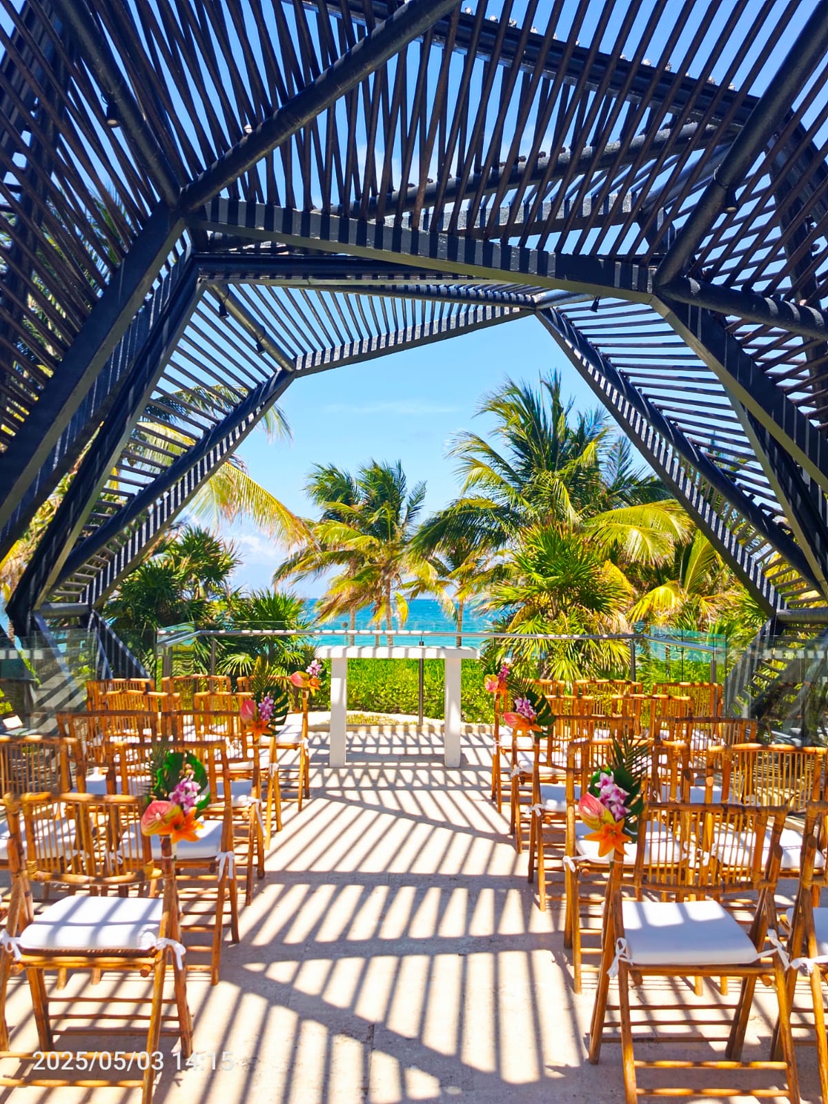 a wedding ceremony with chairs and flowers