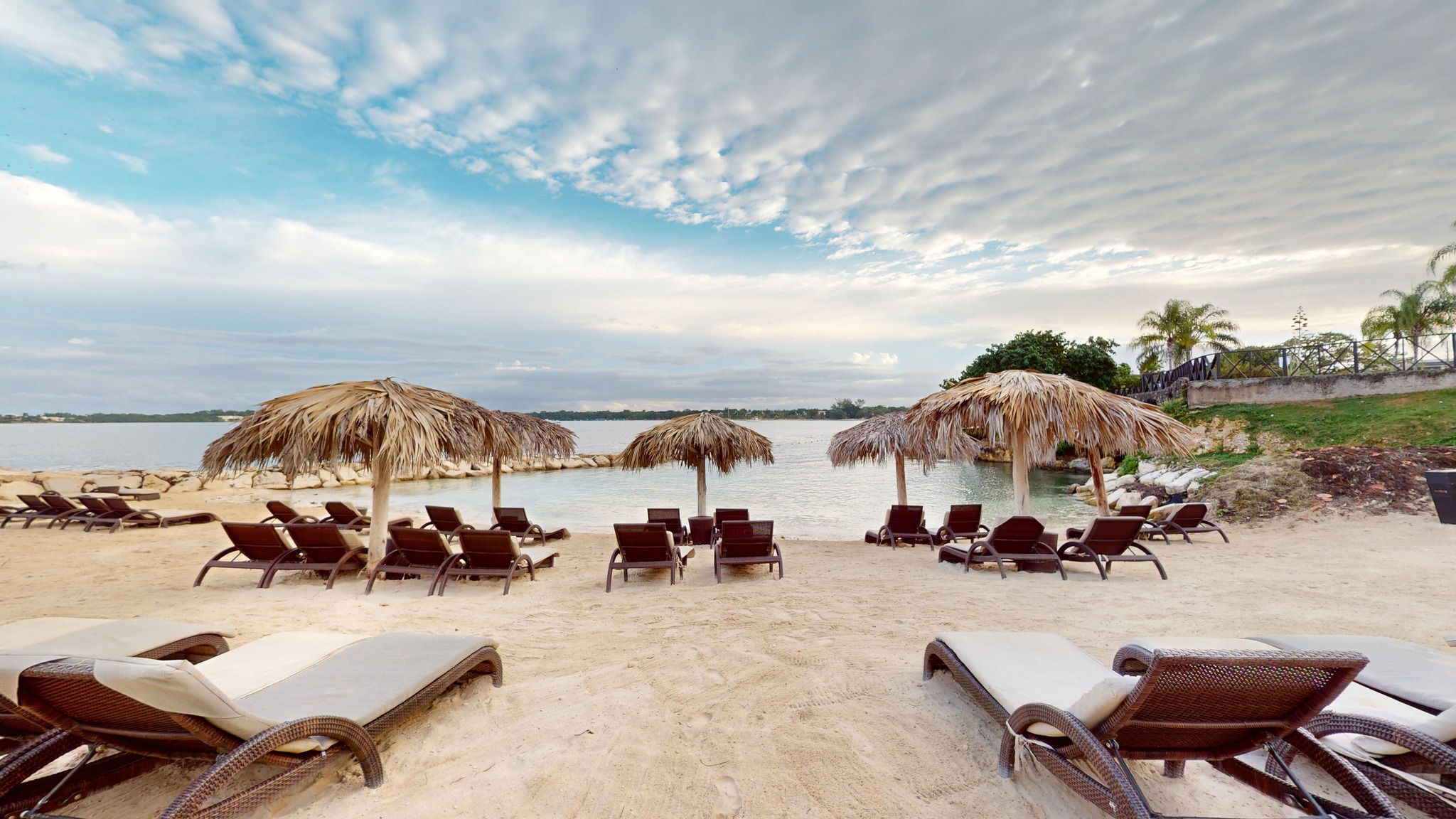a beach with chairs and umbrellas