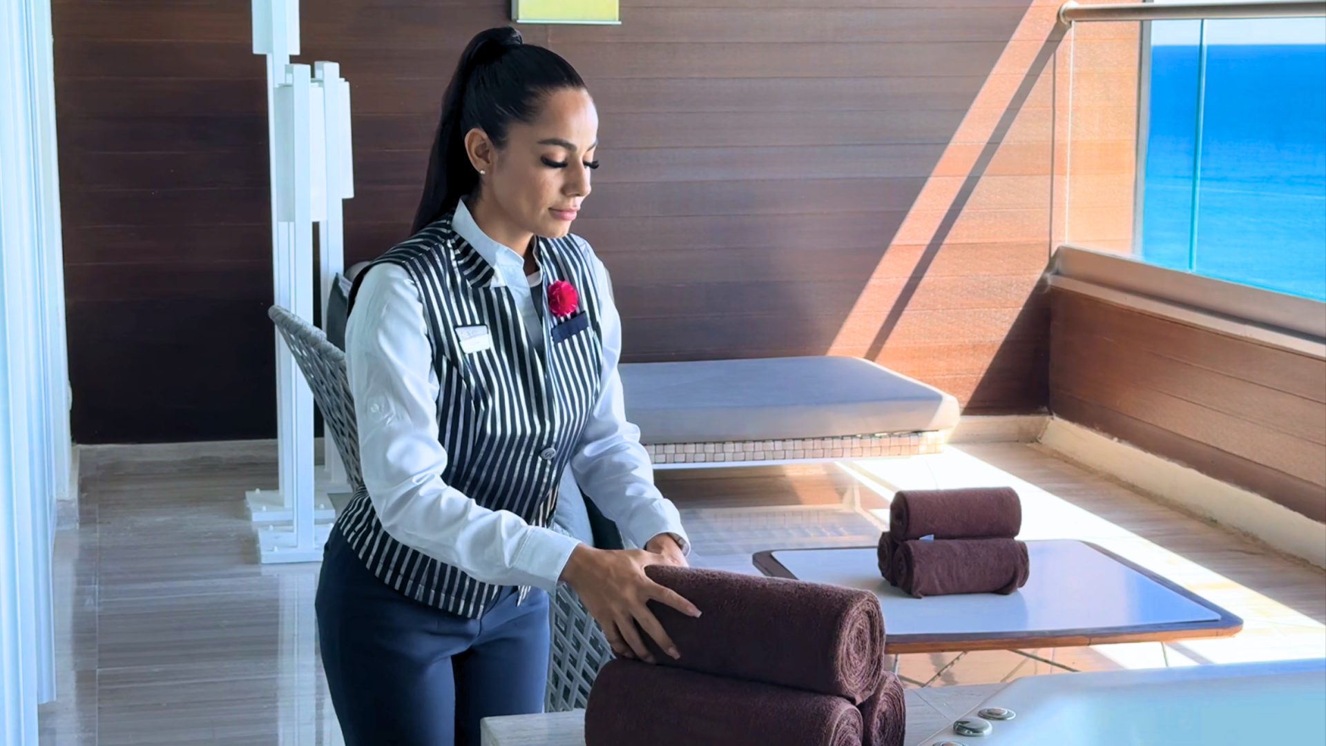 a woman folding towels on a table