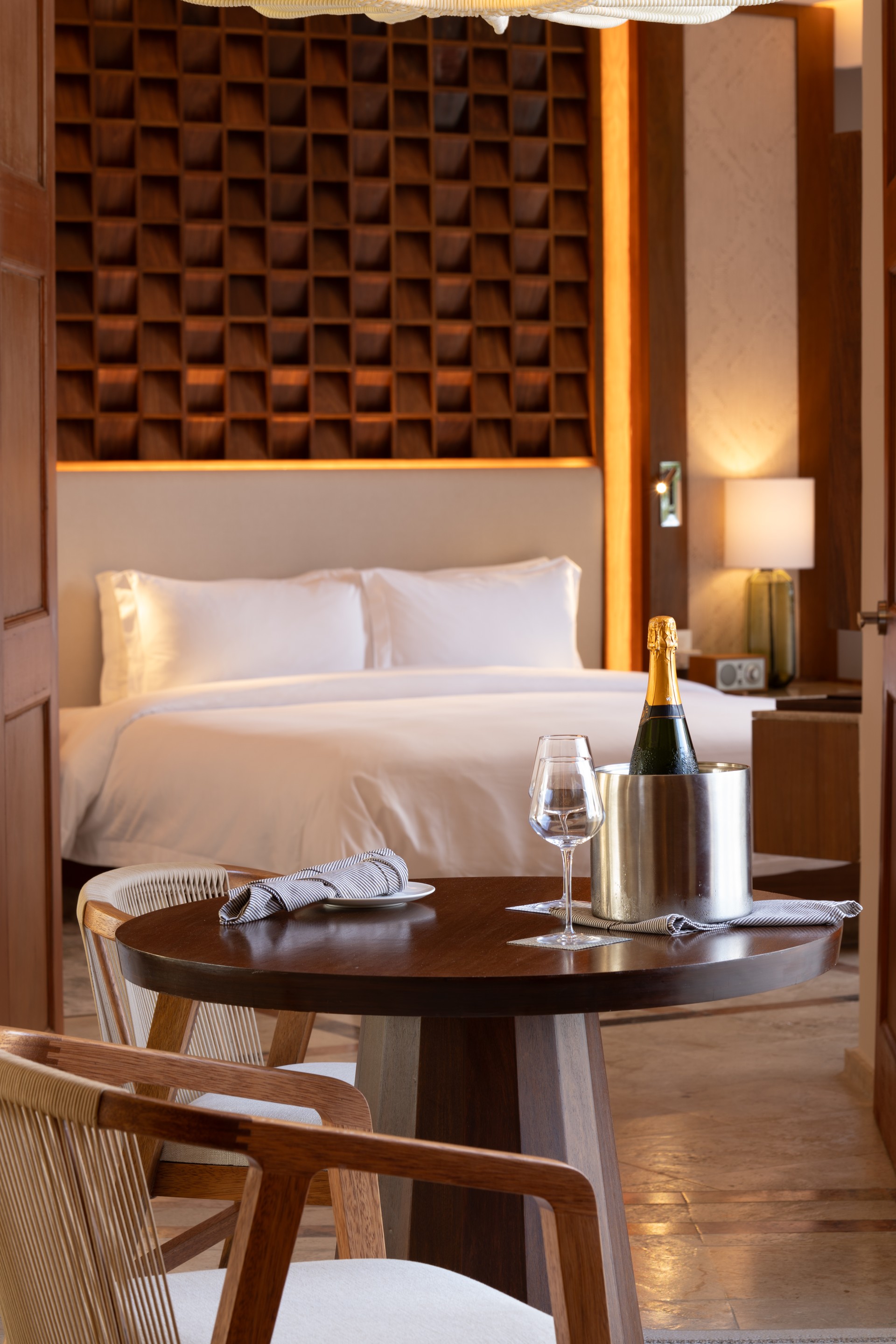 a table with a bottle of champagne and wine glasses on it