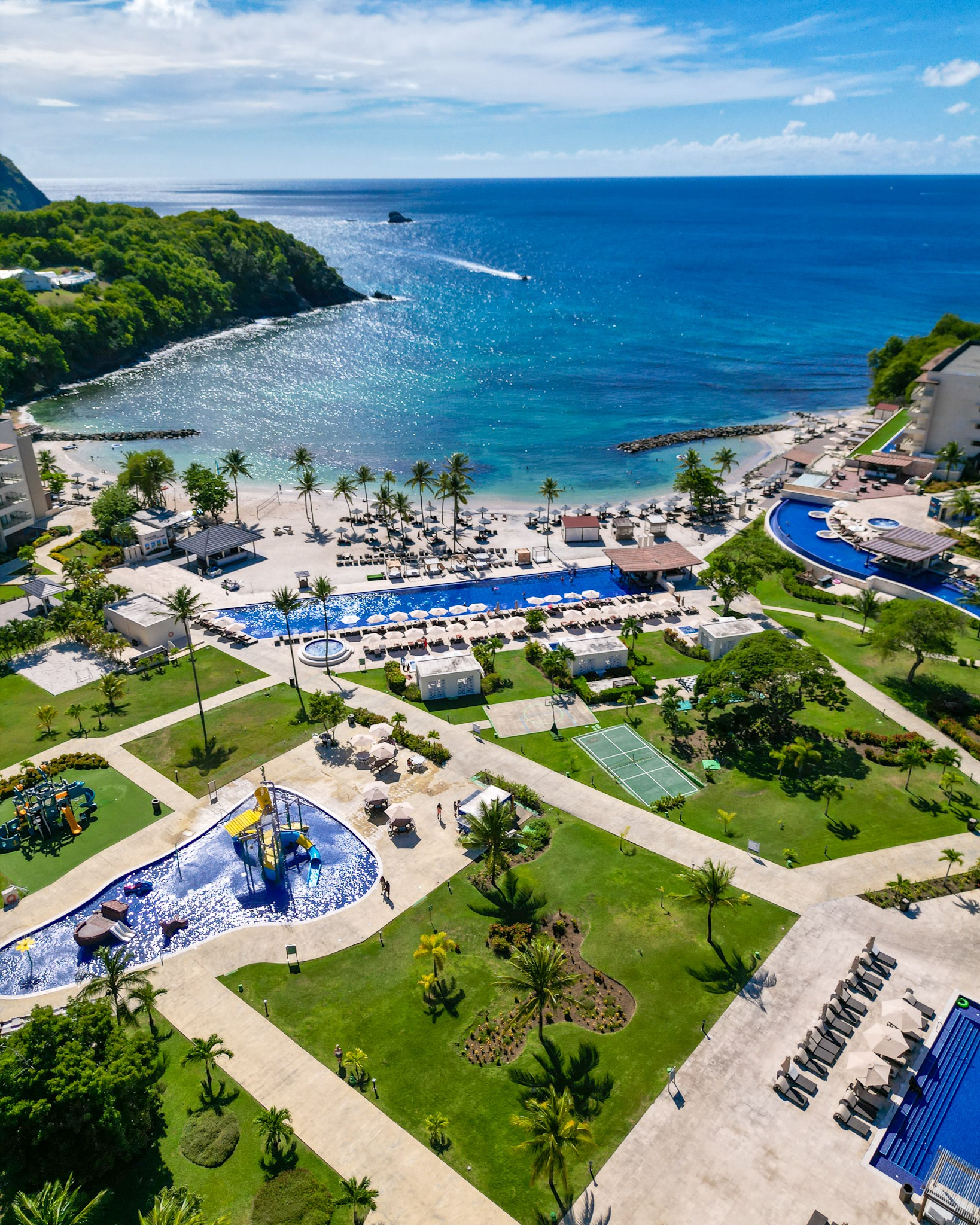 a aerial view of a resort with a pool and a beach