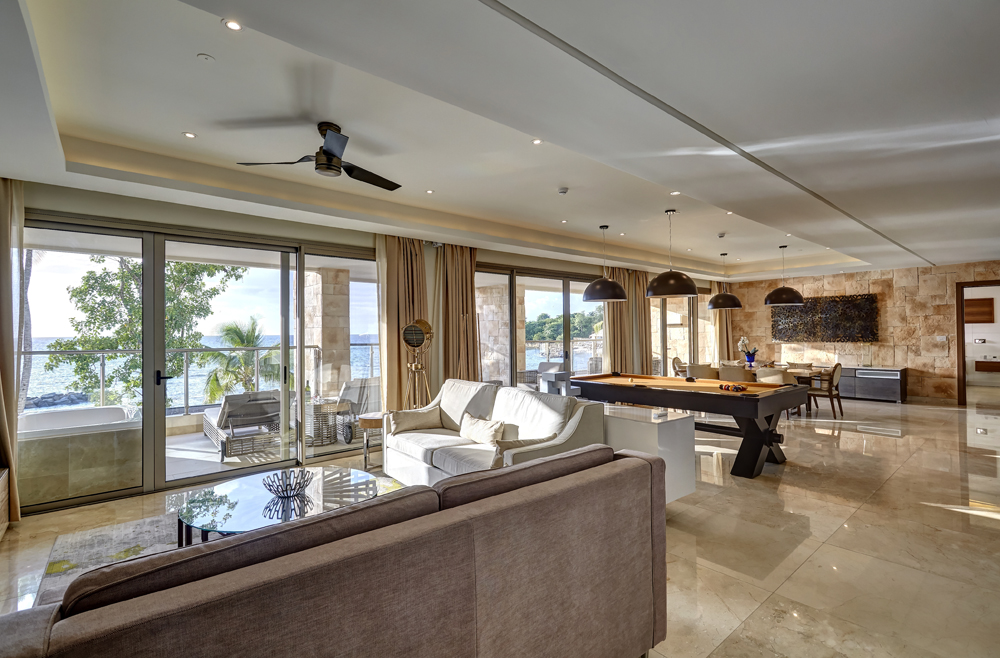 a living room with a pool table and couches