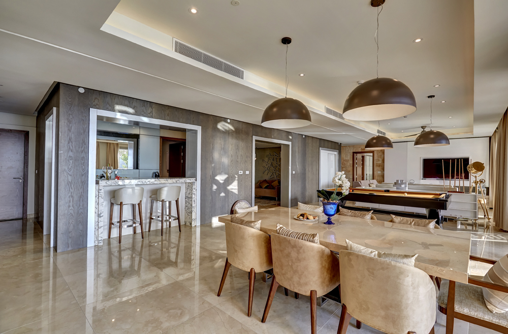 a dining room with a large table and chairs