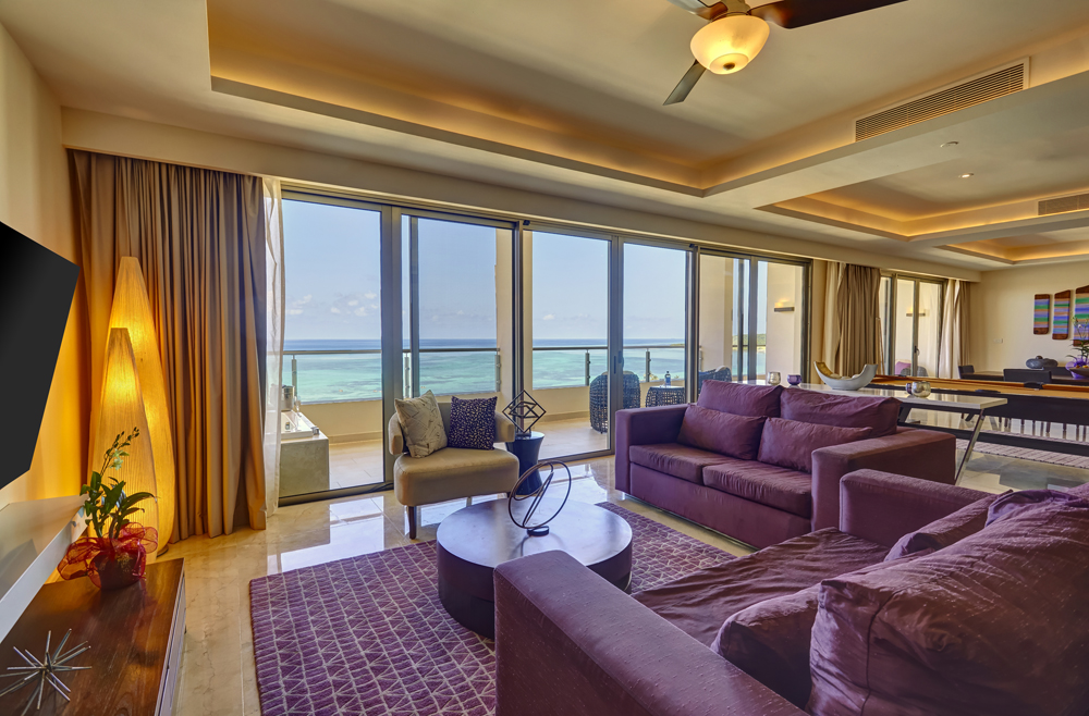 a living room with purple couches and a table