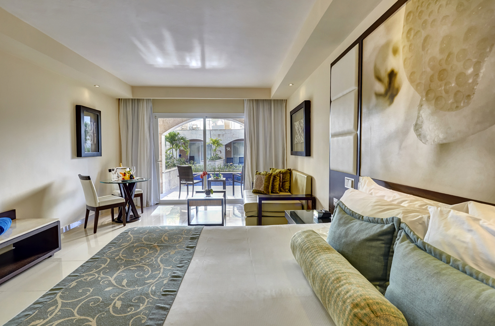 a room with a bed and a table and chairs