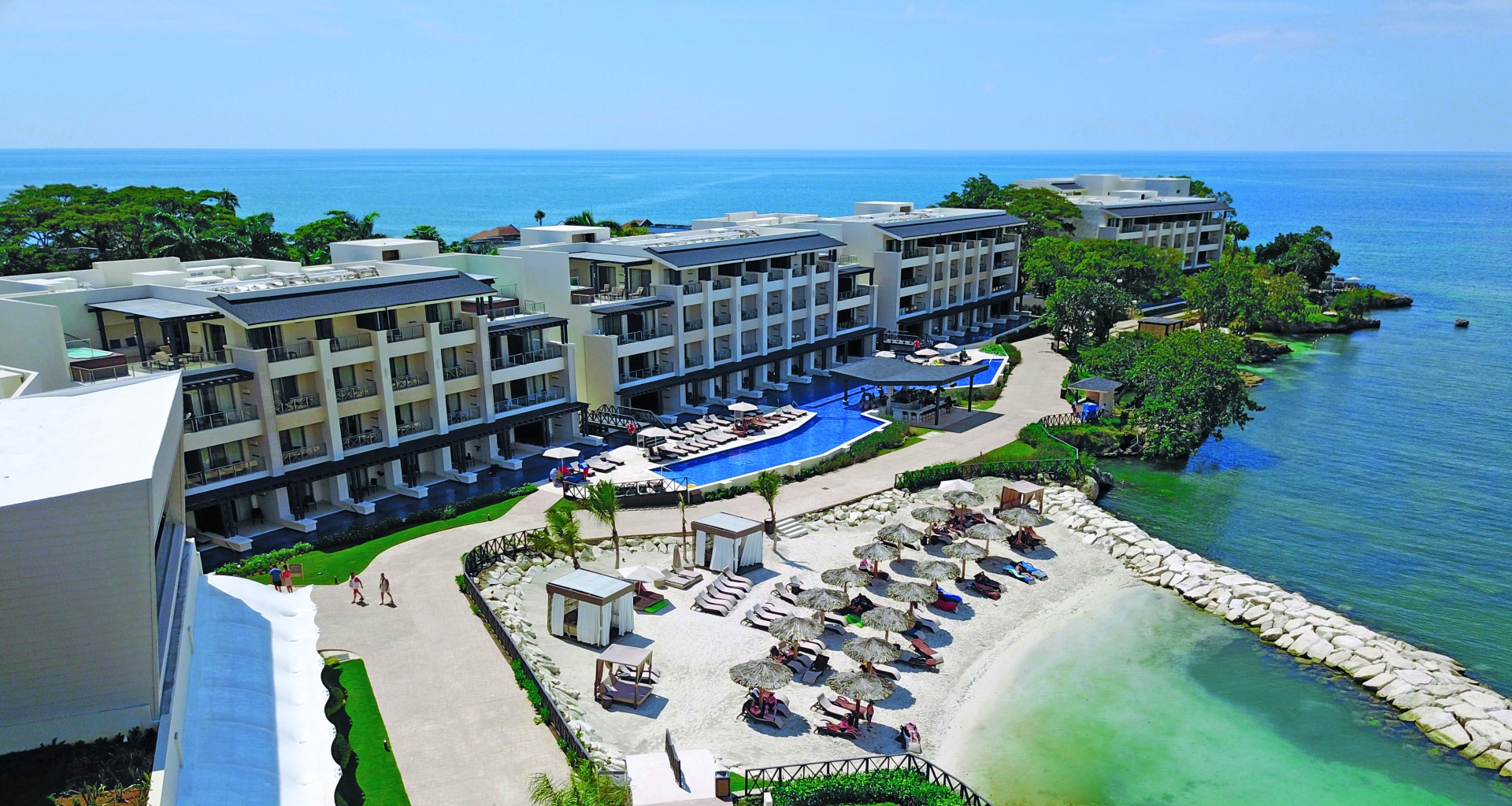 a group of buildings next to a beach