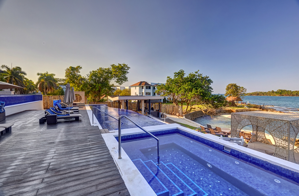 a pool with a deck and chairs