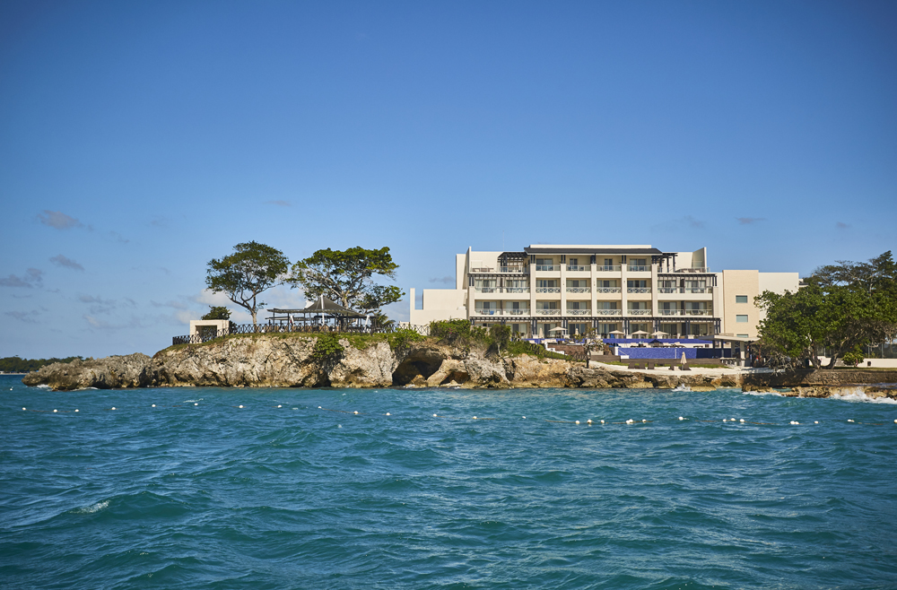 a building on a rocky island by the water
