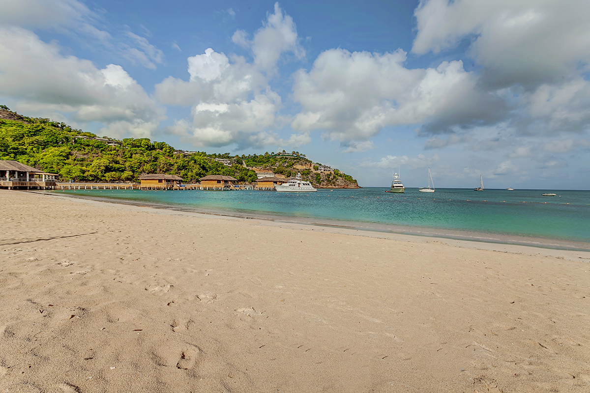 a beach with boats and buildings