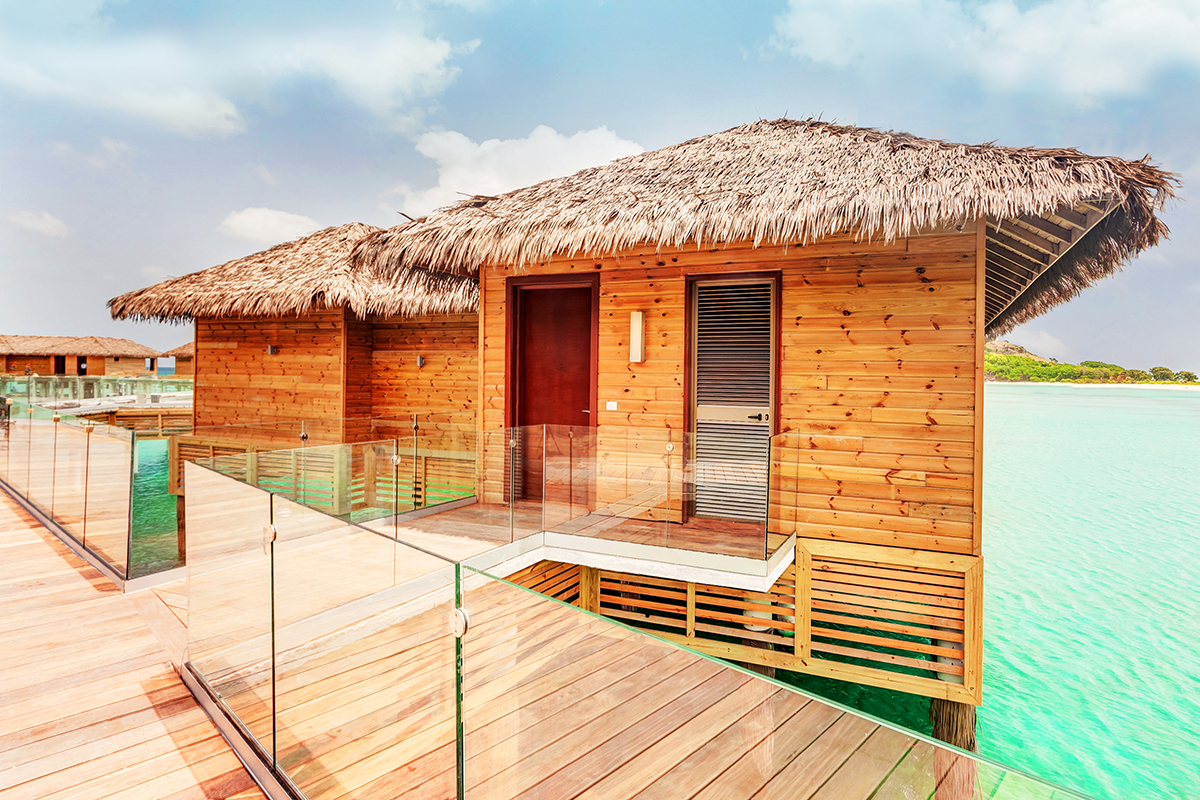 a building with a thatched roof on water