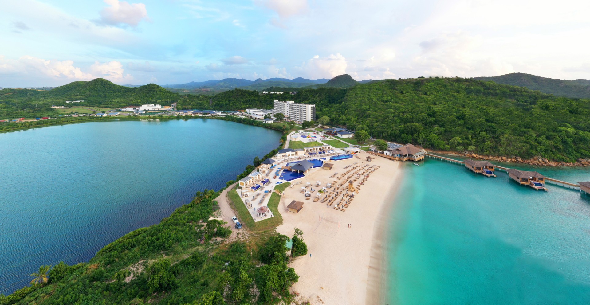 a beach with a body of water and a building