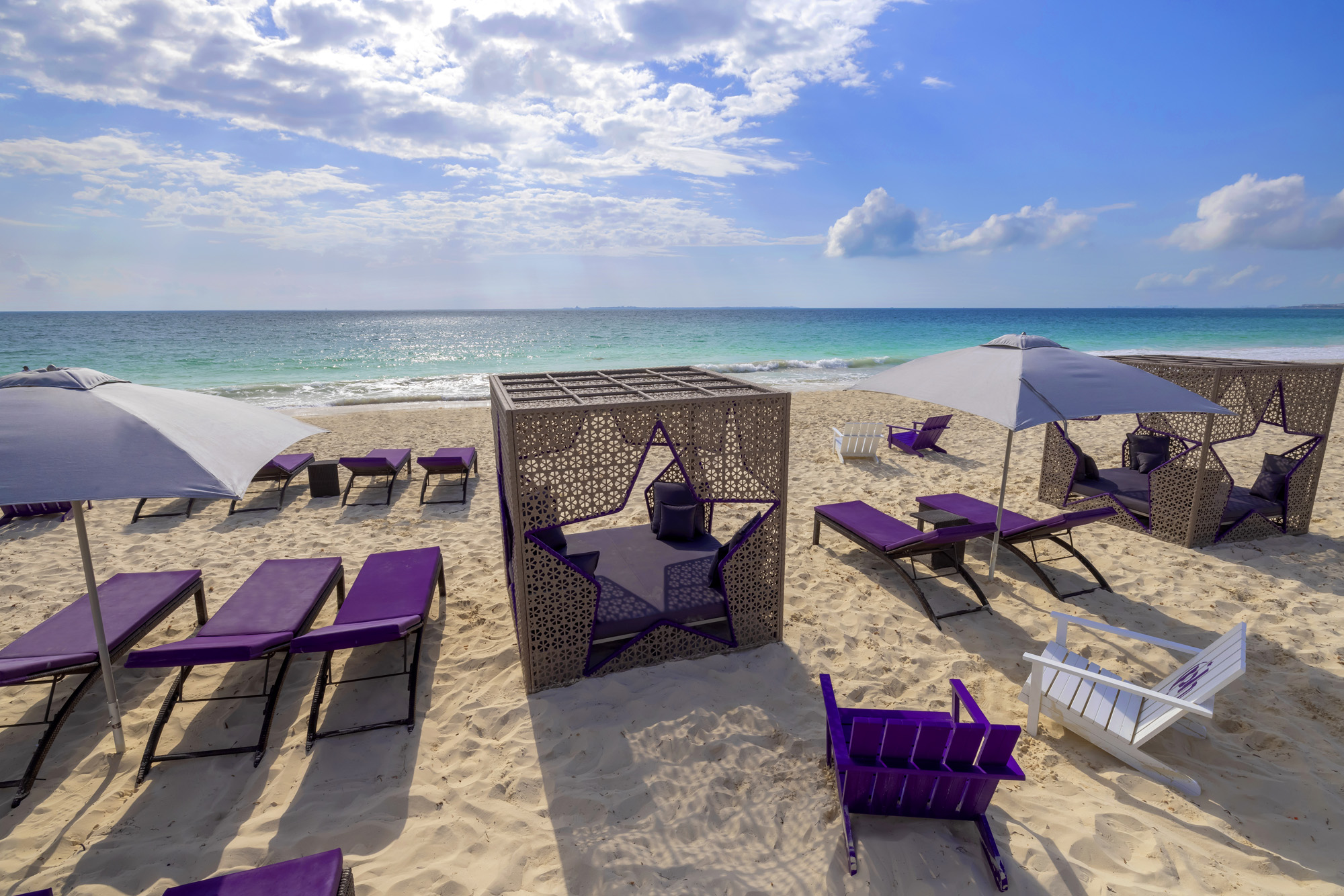 a beach with chairs and umbrellas