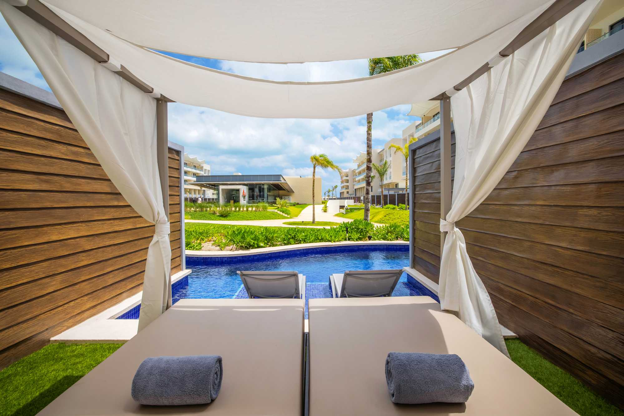 a pool with a bed and chairs