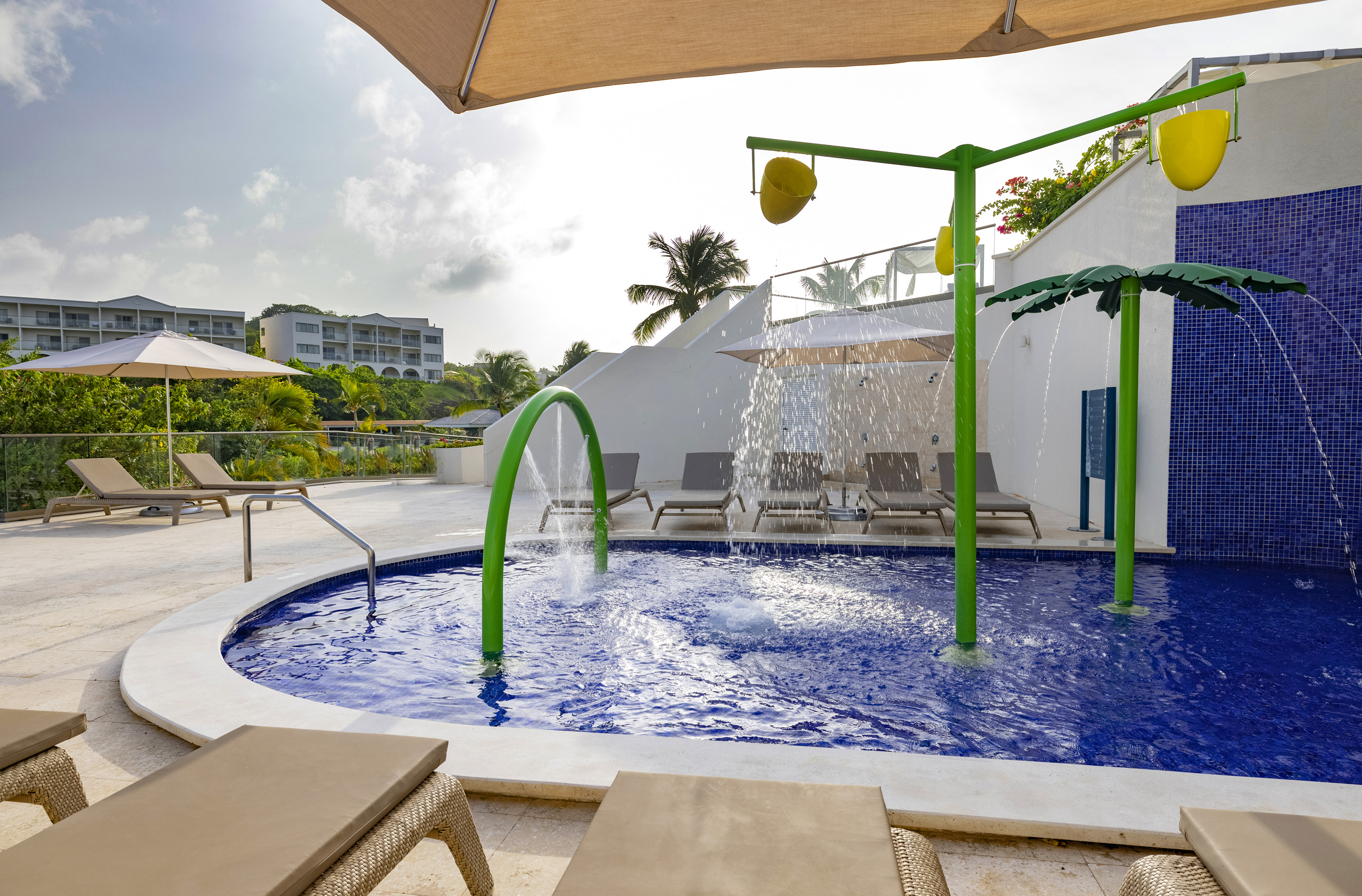 a pool with a shower and a umbrella
