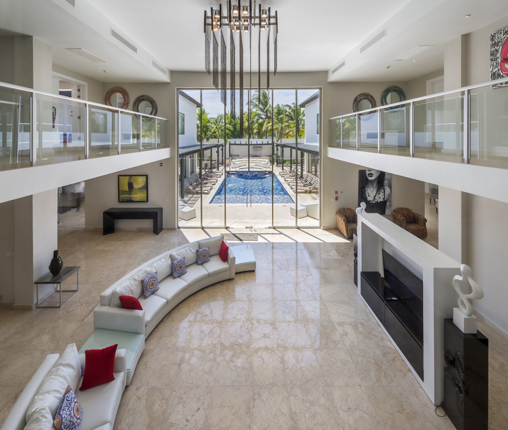 a living room with a pool in the background