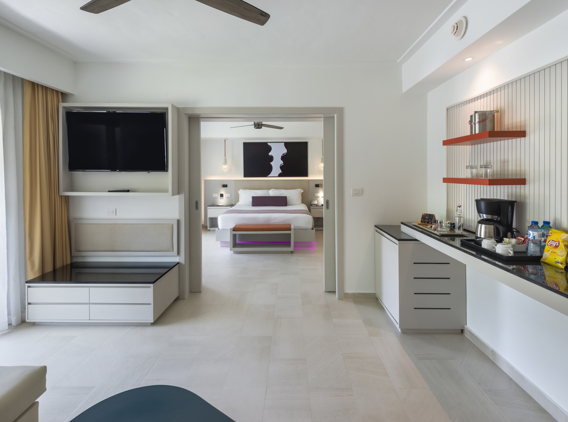 a room with a bed and a tv