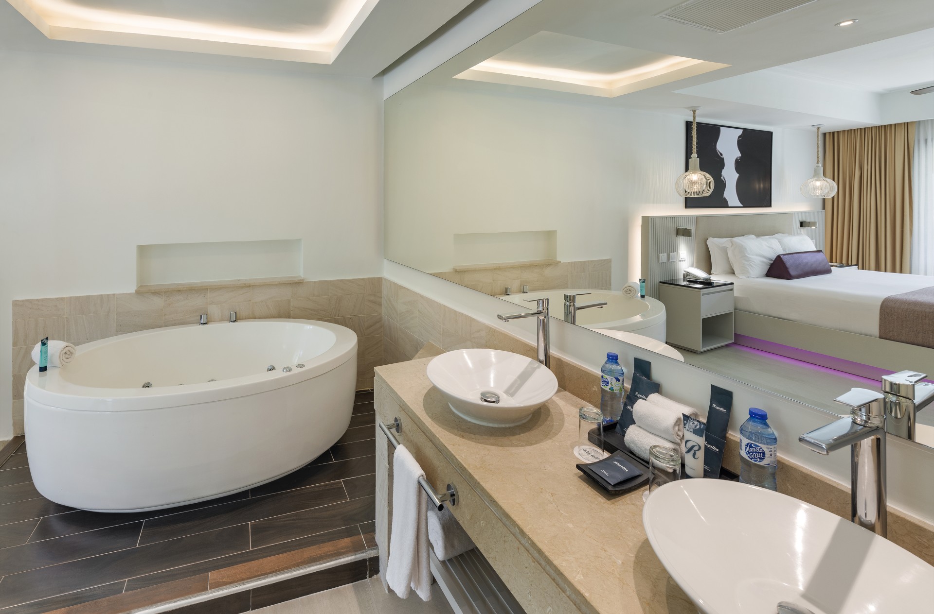 a bathroom with a tub and a large mirror