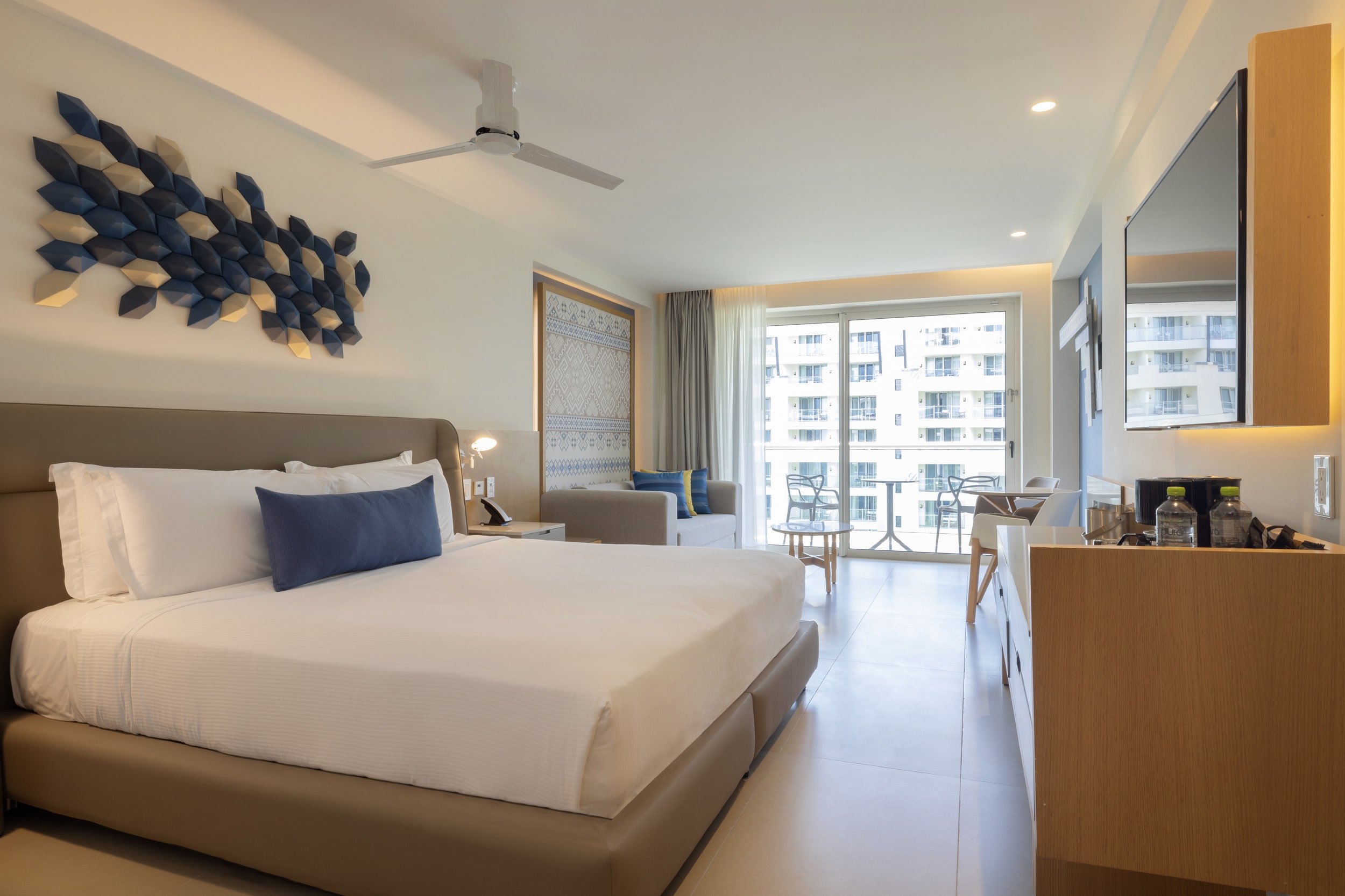 a room with a bed and a table and chairs