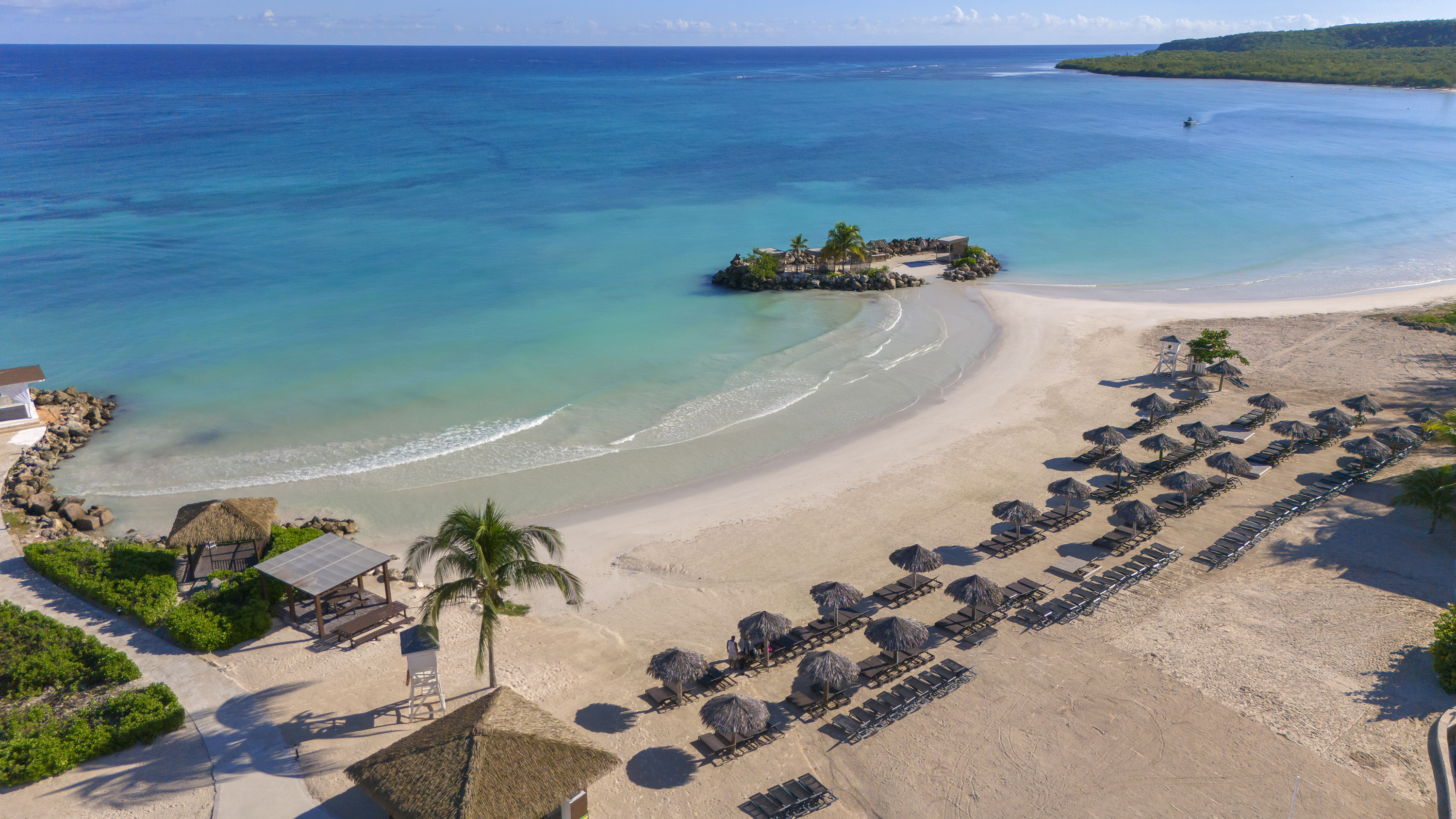 a beach with umbrellas and chairs on a sandy beach