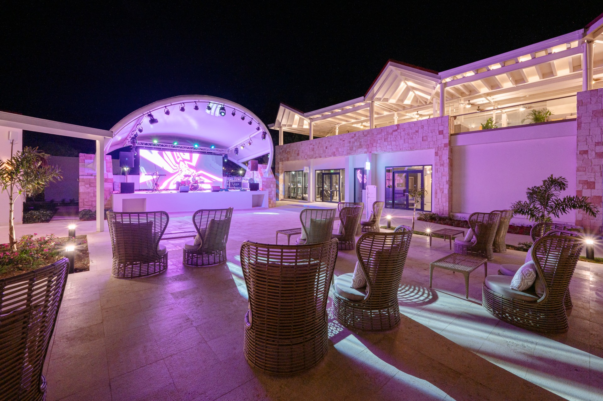 a patio with chairs and a stage in front of it