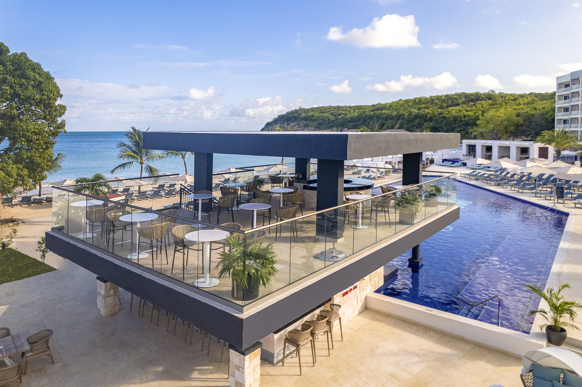 a building with a pool and tables