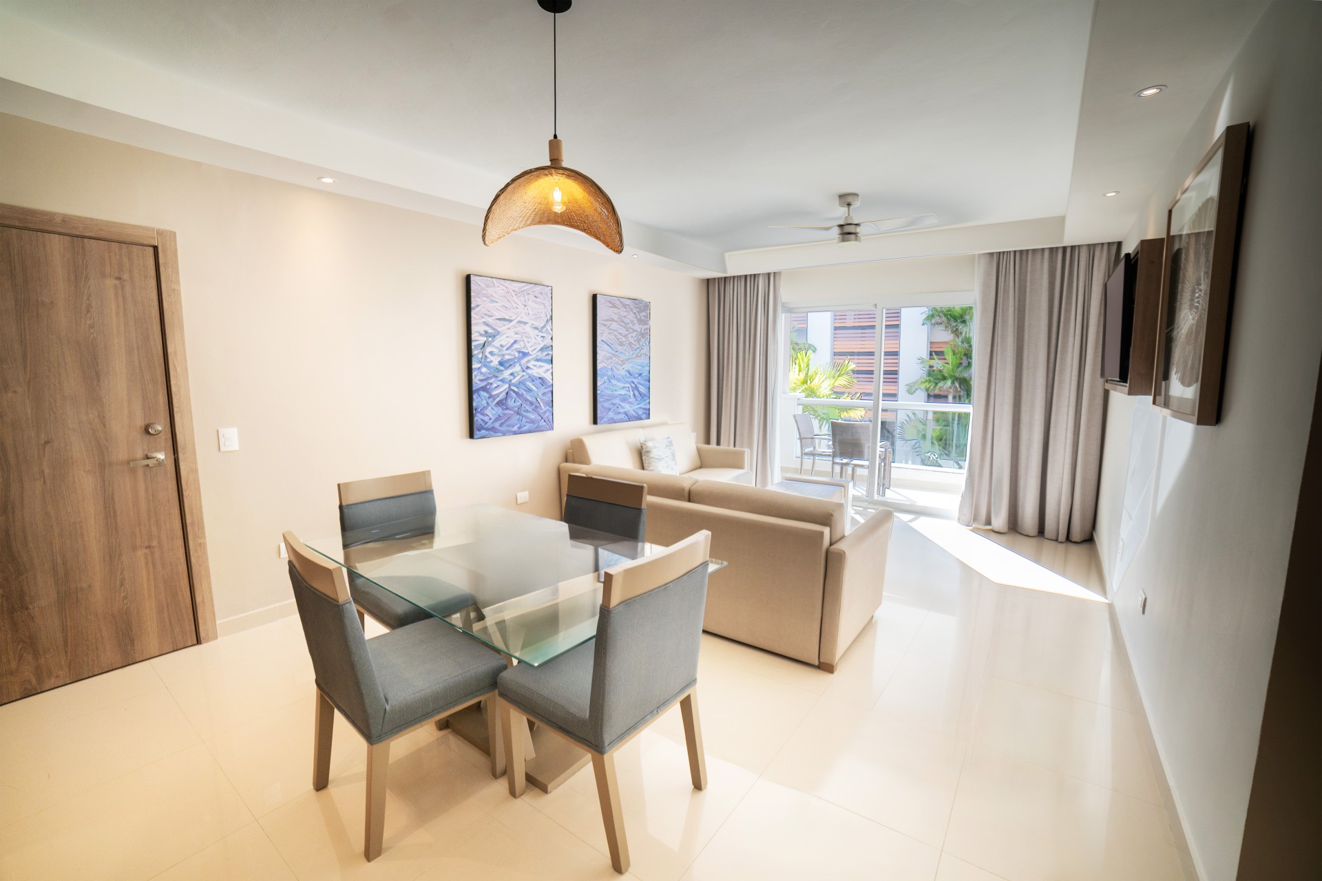 a living room with a glass table and chairs