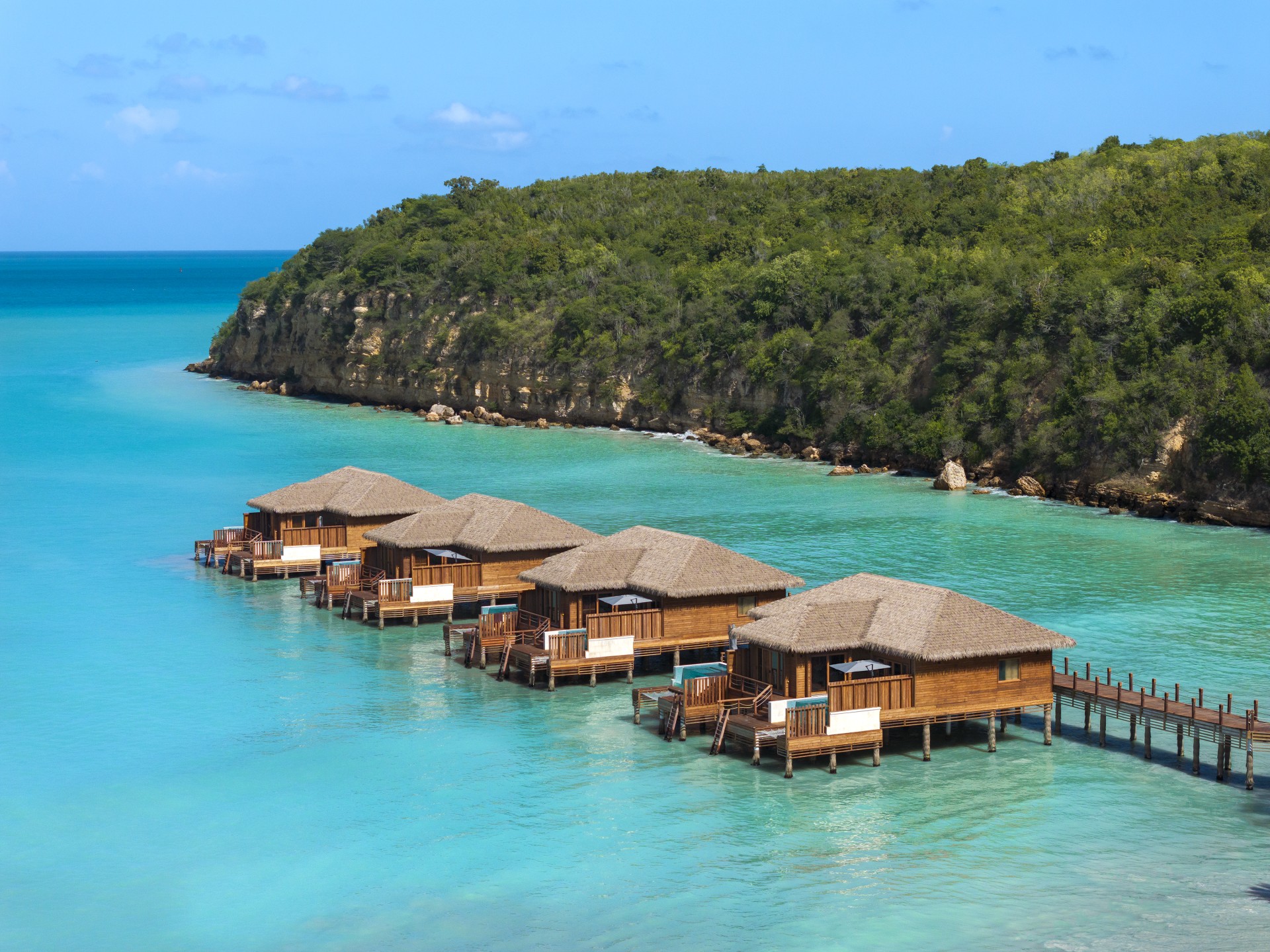 a group of huts on stilts in water