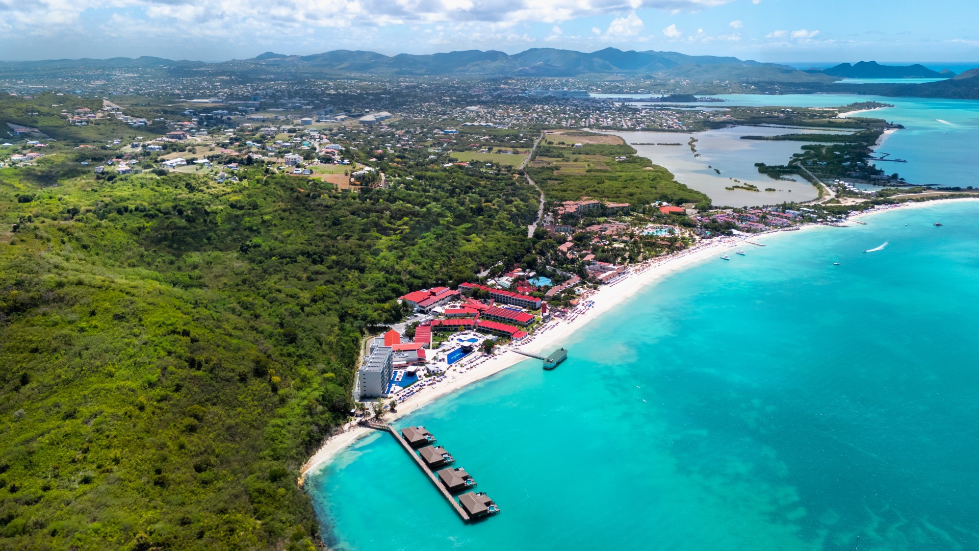 a beach with buildings and a body of water