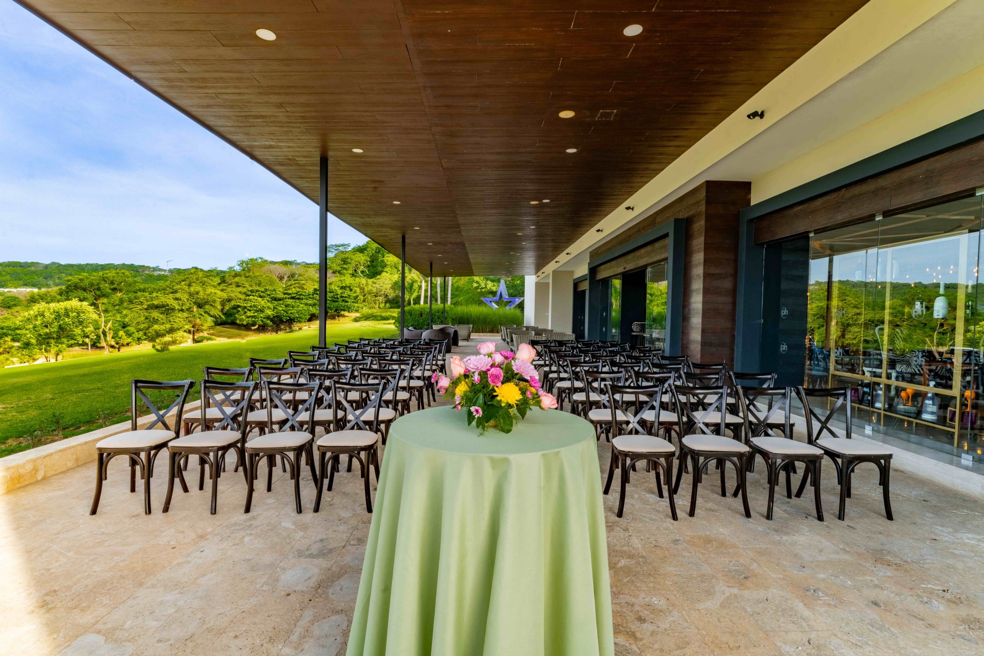 a table with flowers on it and chairs in a row