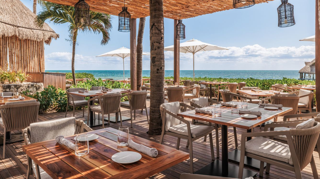 a restaurant with tables and chairs and umbrellas