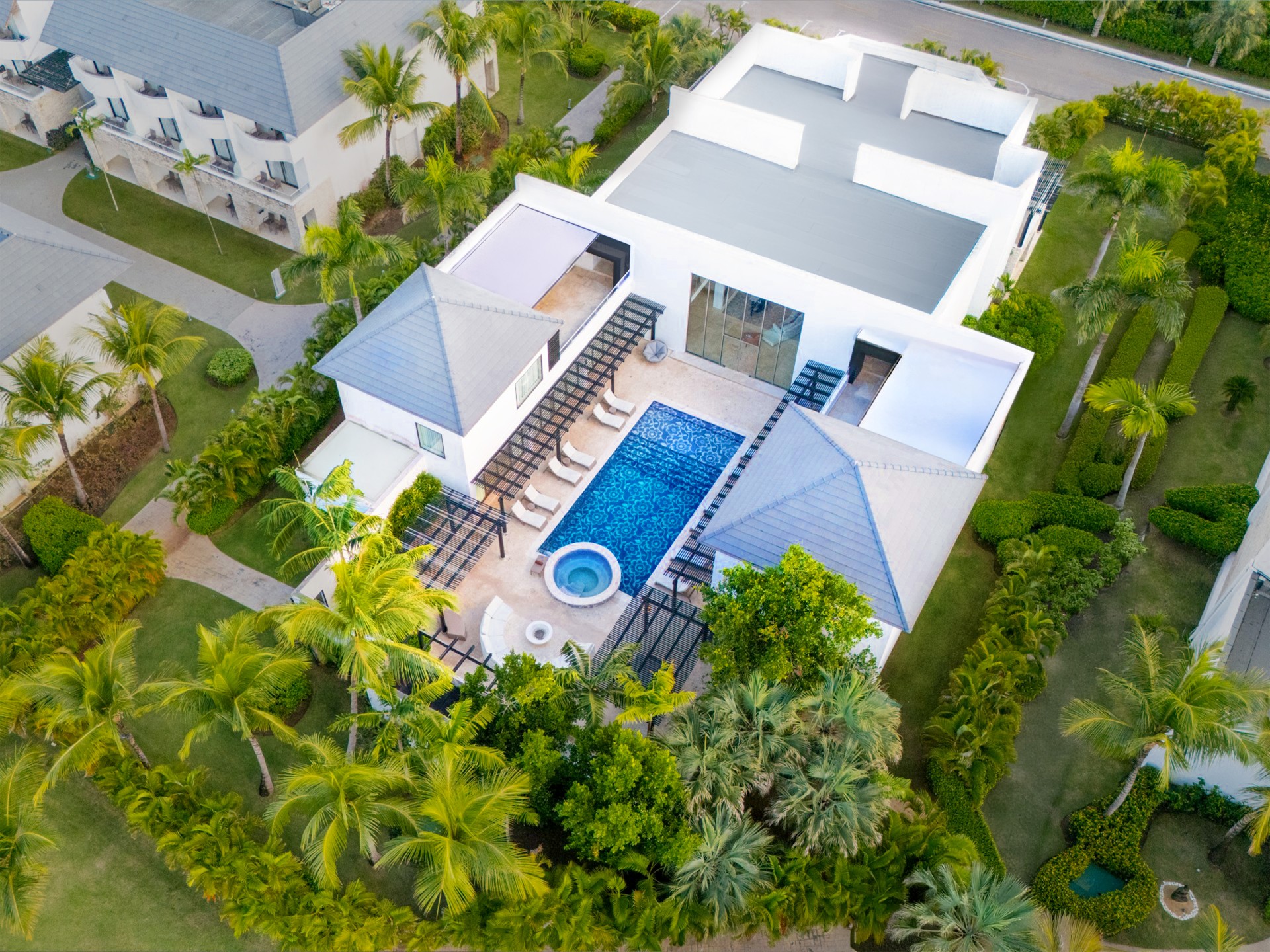a pool in a house surrounded by palm trees